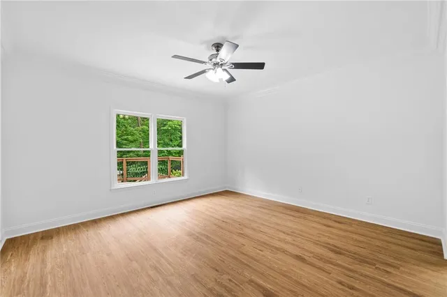 a large kitchen with stainless steel appliances kitchen island granite countertop a table and chairs in it