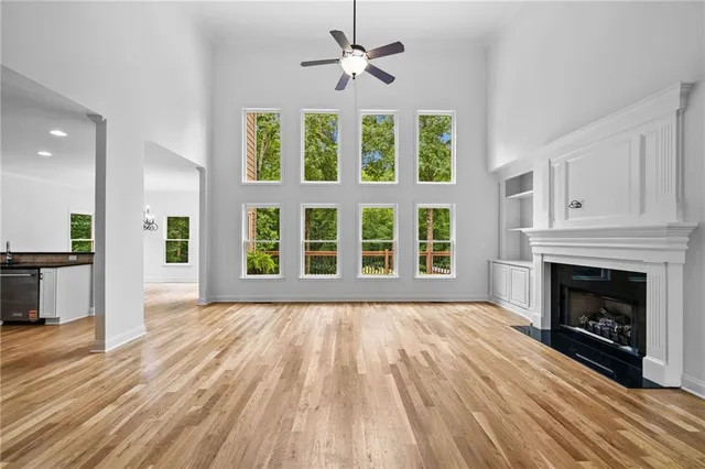a kitchen with granite countertop a center island attached withe living room