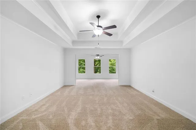 a view of an empty room with a ceiling fan