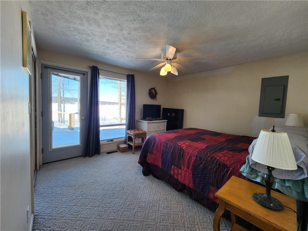 224 Latonka Drive Mercer, PA 16137 - Photo 34 of 42 a spacious bedroom with a bed chandelier and a window