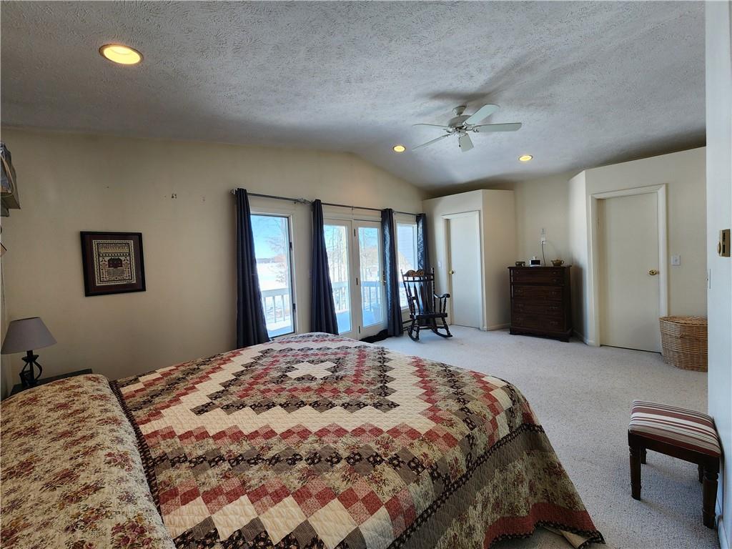 224 Latonka Drive Mercer, PA 16137 - Photo 39 of 42 a bedroom with a large bed and a chandelier