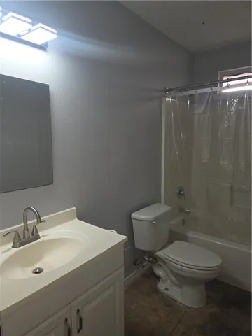 a bathroom with a toilet a sink and shower