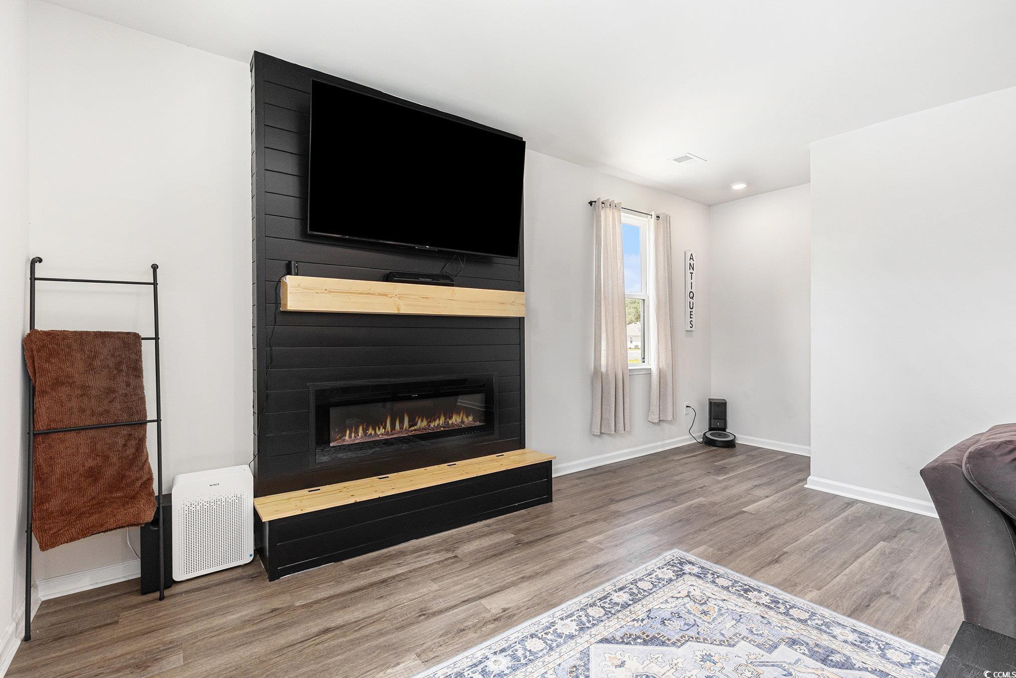 651 Choctaw Drive Conway, SC 29526 - Photo 11 of 37 Unfurnished living room with light wood finished floors, a large fireplace, and recessed lighting