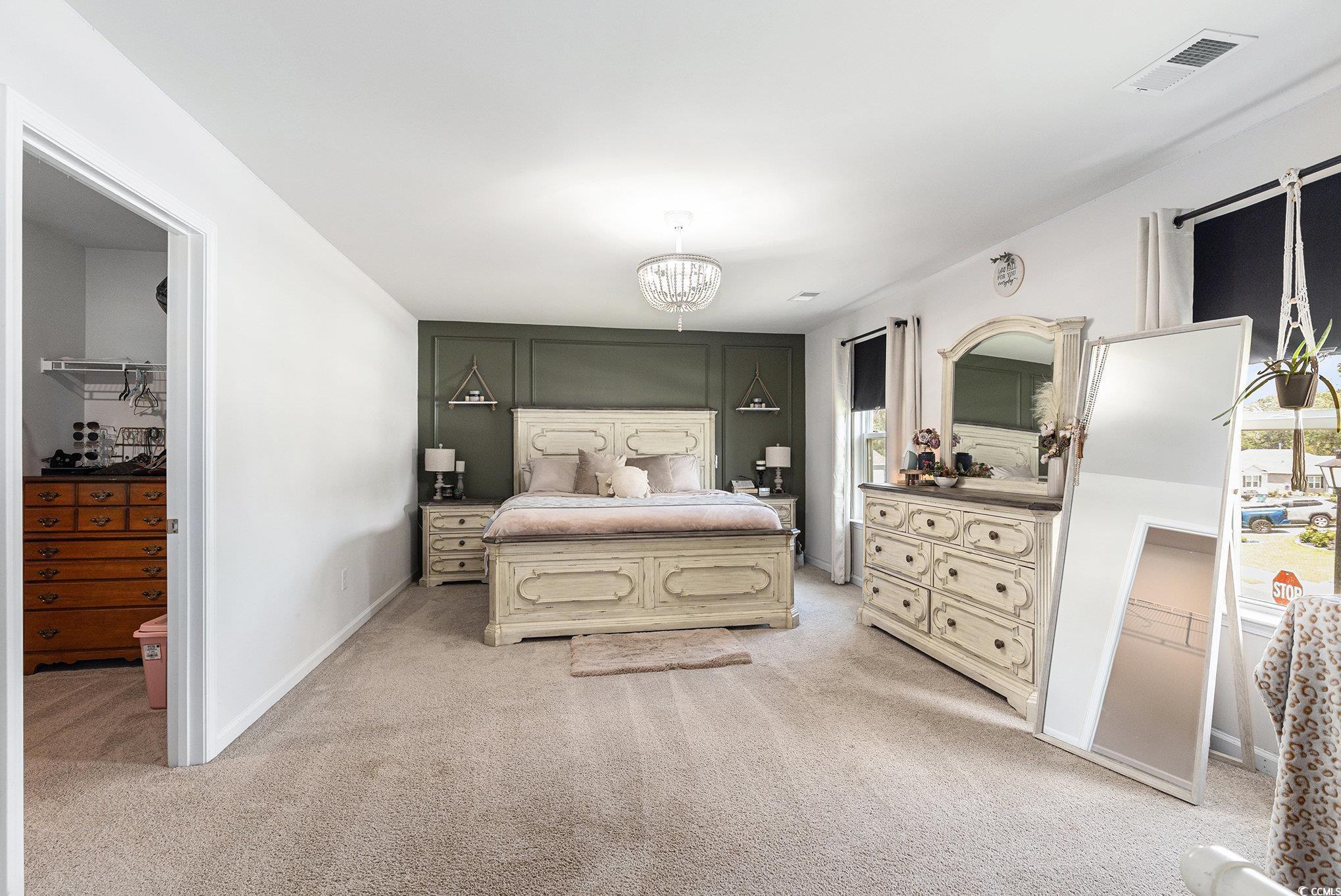 651 Choctaw Drive Conway, SC 29526 - Photo 14 of 37 Bedroom with light colored carpet, multiple windows, and a chandelier