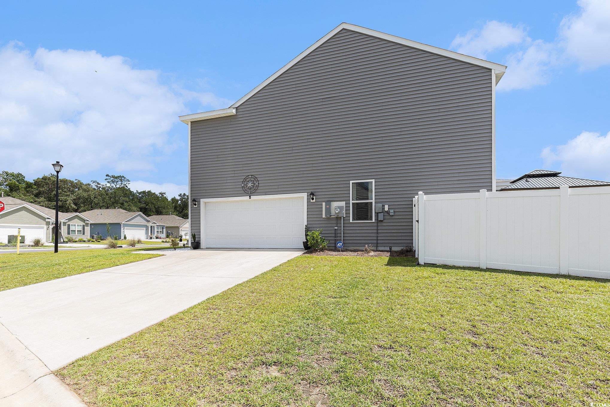 651 Choctaw Drive Conway, SC 29526 - Photo 31 of 37 View of property exterior featuring an attached garage and driveway