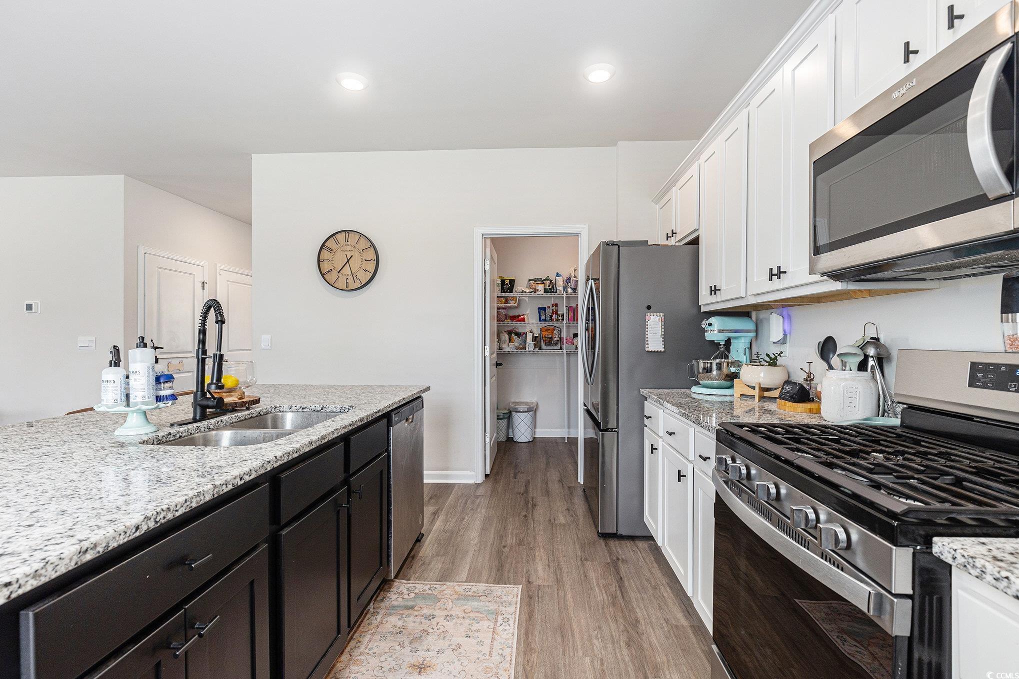 651 Choctaw Drive Conway, SC 29526 - Photo 6 of 37 Kitchen with stainless steel appliances, light stone countertops, white cabinetry, light wood-style flooring, and recessed lighting