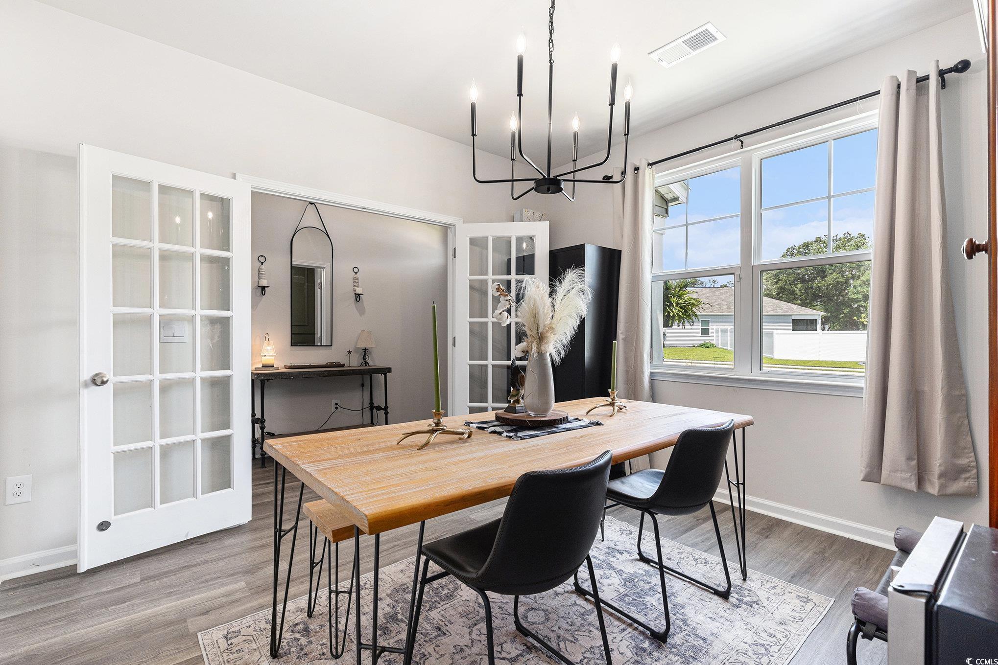 651 Choctaw Drive Conway, SC 29526 - Photo 9 of 37 Dining room featuring wood finished floors and a chandelier