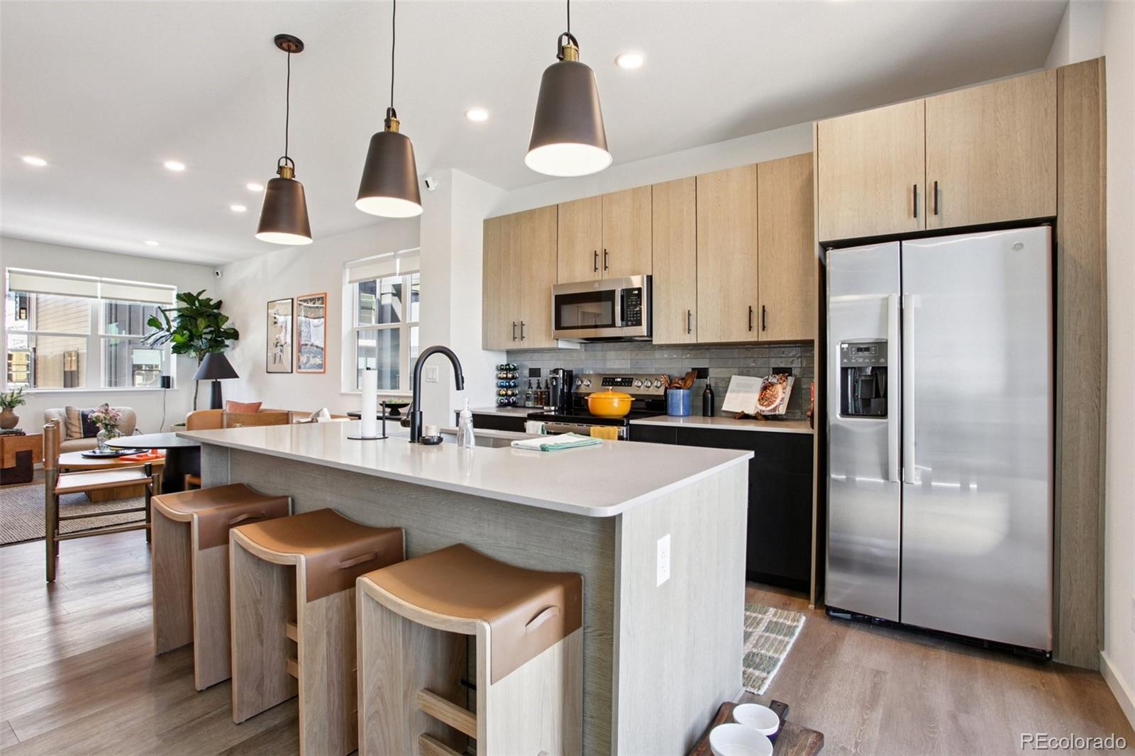 6419 Meade Way Arvada, CO 80003 - Photo 1 of 29 a kitchen with granite countertop a center island a sink stainless steel appliances and cabinets