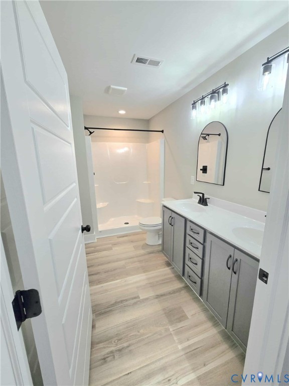 1775 Bumpass Road Bumpass, VA 23024 - Photo 13 of 42 a bathroom with double vanity sink and mirror