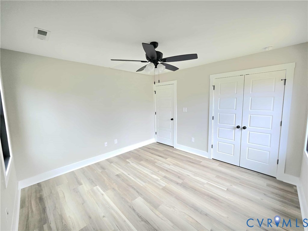 1775 Bumpass Road Bumpass, VA 23024 - Photo 20 of 42 a view of a chandelier fan and hardwood floor in a room