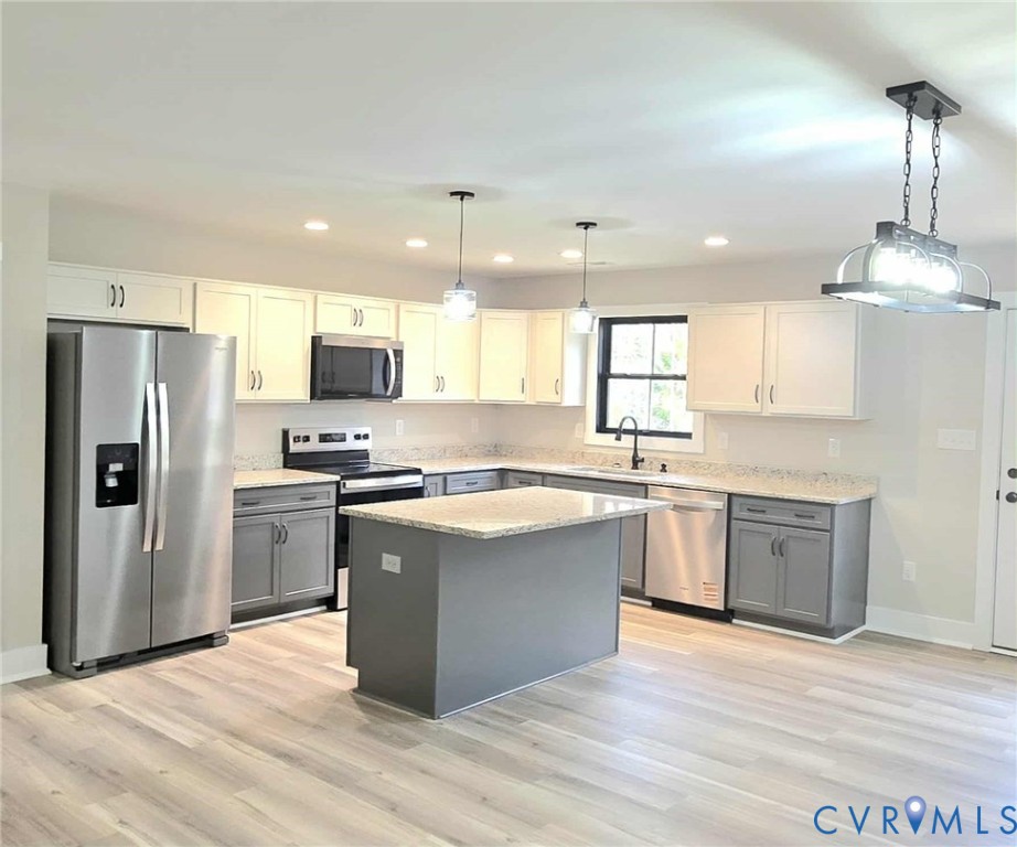 1775 Bumpass Road Bumpass, VA 23024 - Photo 34 of 42 a large kitchen with cabinets wooden floor and stainless steel appliances