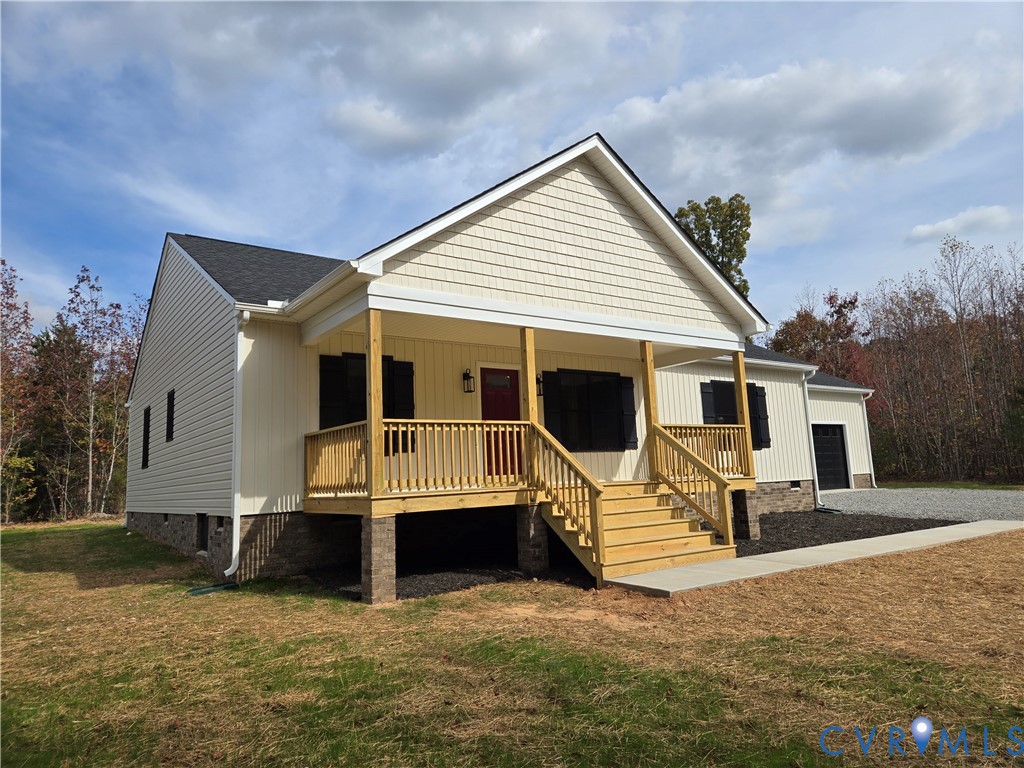 1775 Bumpass Road Bumpass, VA 23024 - Photo 4 of 42 a view of a house with wooden wall next to a yard