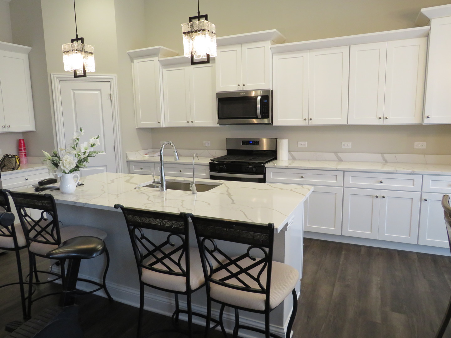 21407 Bay Tree Court Shorewood, IL 60404 - Photo 17 of 53 a kitchen with stainless steel appliances a sink a stove a table and chairs