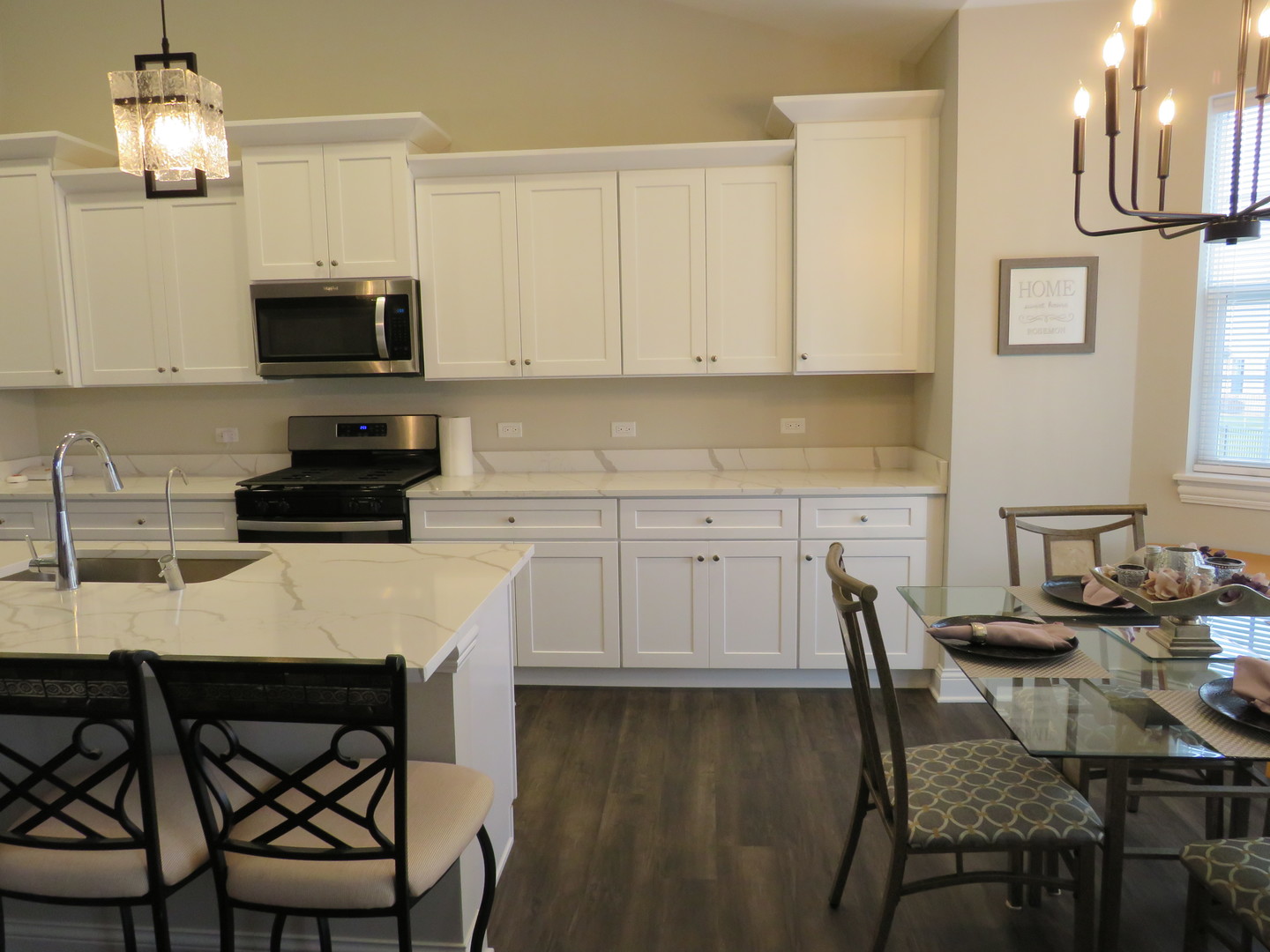 21407 Bay Tree Court Shorewood, IL 60404 - Photo 18 of 53 a kitchen with stainless steel appliances a dining table chairs and a refrigerator