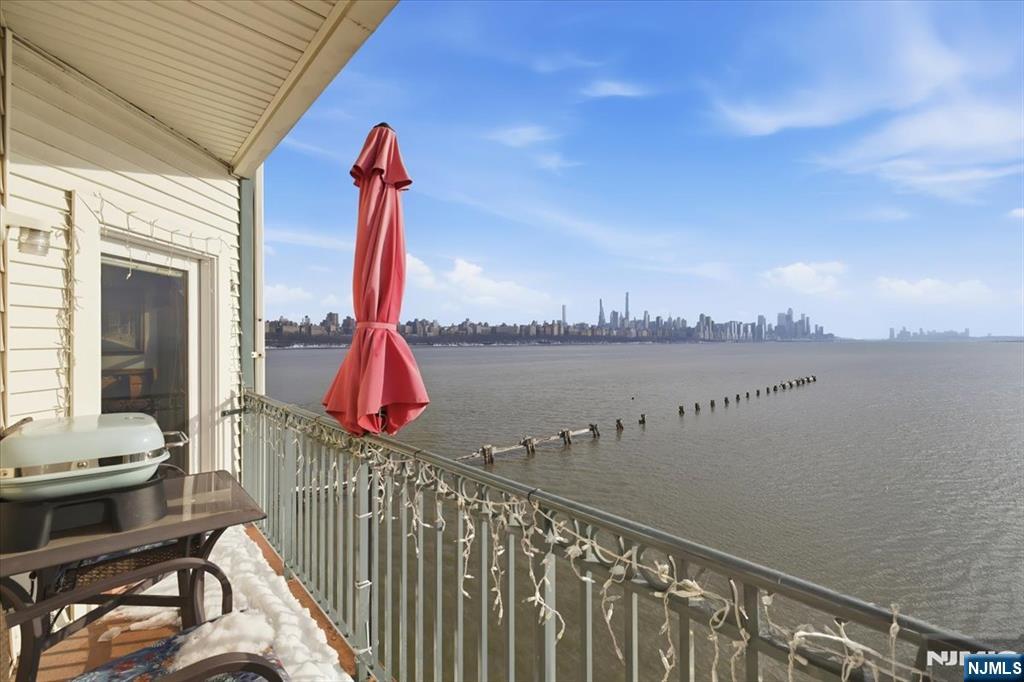214 The Promenade, Unit 214 Edgewater, NJ 07020 - Photo 11 of 36 a view of a balcony with chair and wooden floor