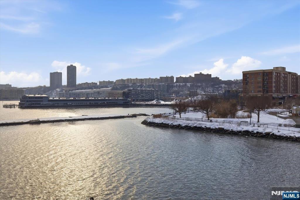 214 The Promenade, Unit 214 Edgewater, NJ 07020 - Photo 13 of 36 a view of a lake with houses