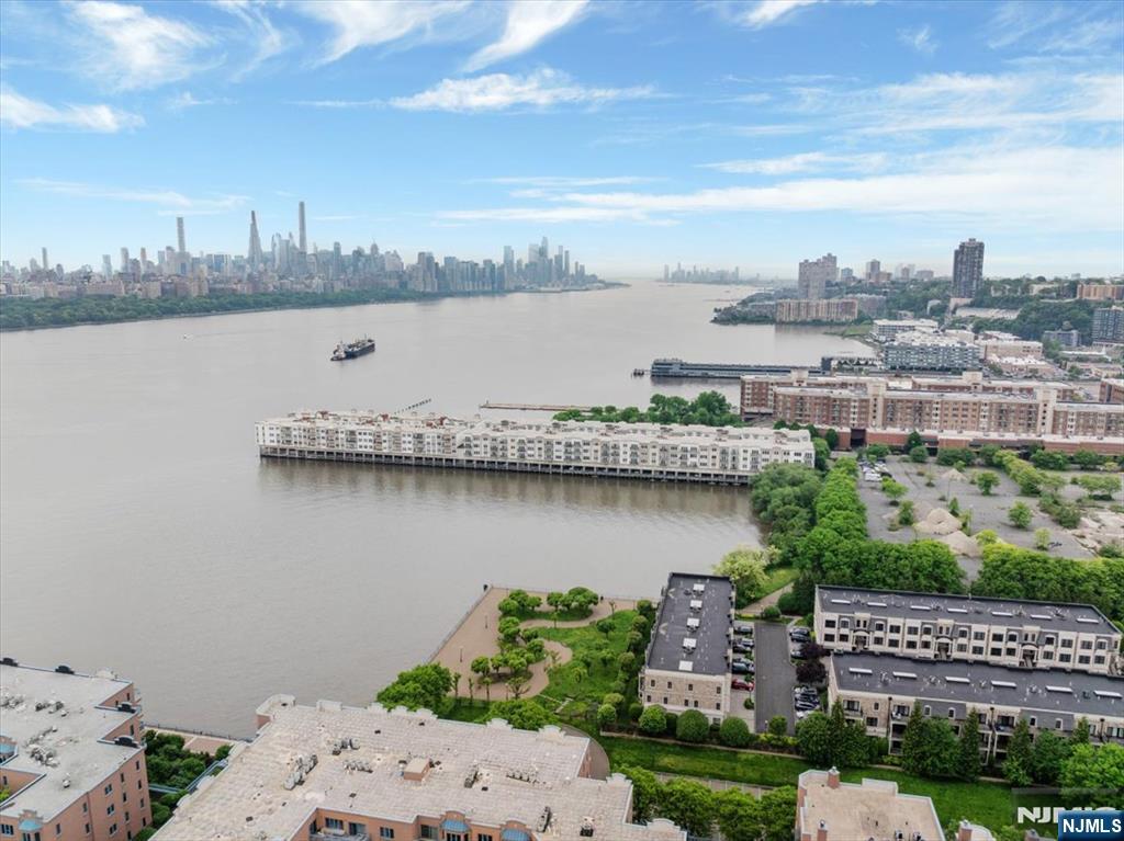 214 The Promenade, Unit 214 Edgewater, NJ 07020 - Photo 15 of 36 a view of a lake with a city skyline in the background