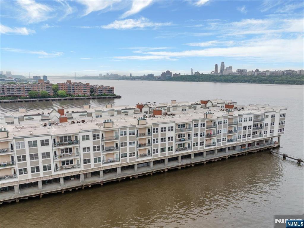214 The Promenade, Unit 214 Edgewater, NJ 07020 - Photo 16 of 36 a view of a lake with tall buildings