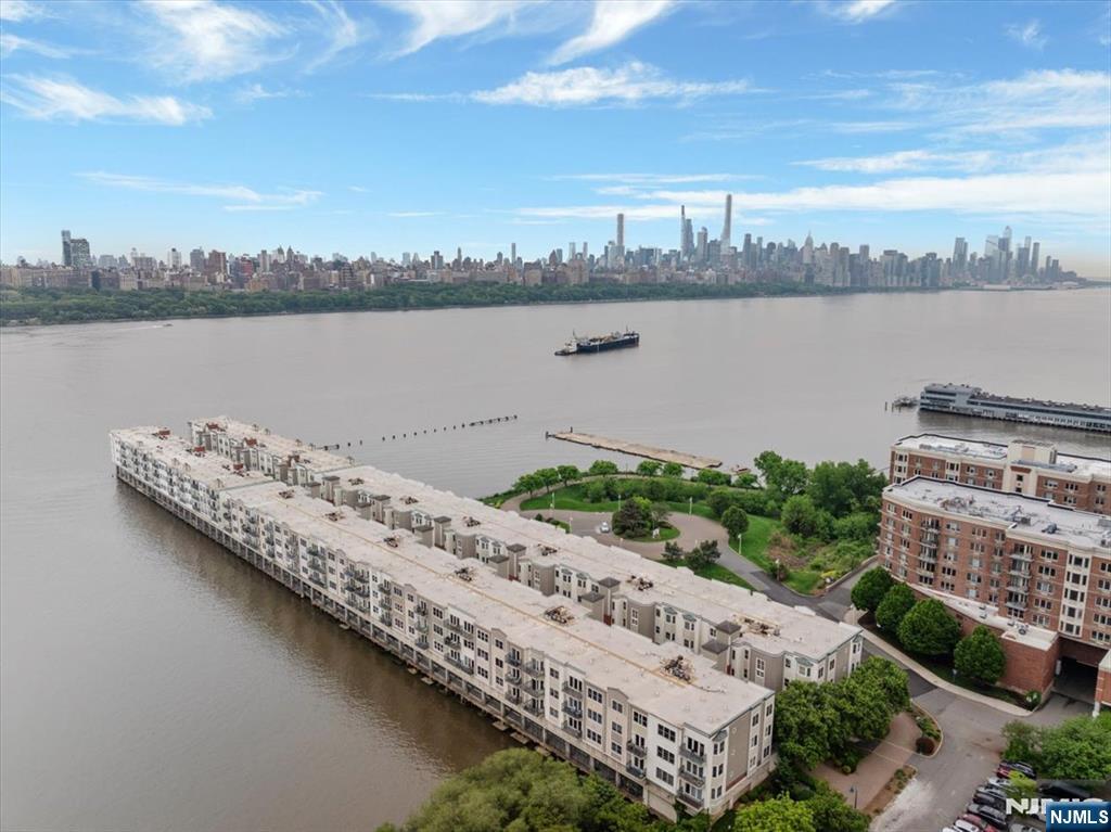 214 The Promenade, Unit 214 Edgewater, NJ 07020 - Photo 17 of 36 a view of a lake with a city
