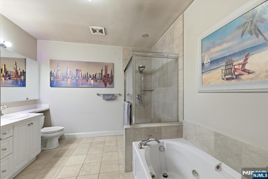 214 The Promenade, Unit 214 Edgewater, NJ 07020 - Photo 23 of 36 a bathroom with a tub toilet and sink