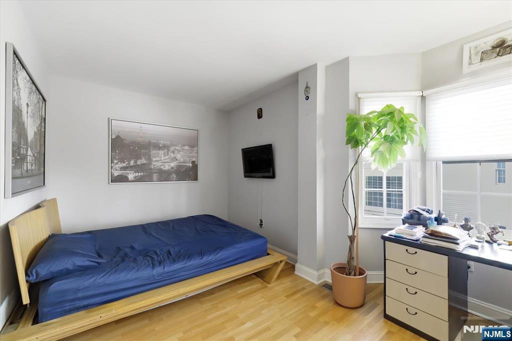 214 The Promenade, Unit 214 Edgewater, NJ 07020 - Photo 30 of 36 a living room with furniture and a flat screen tv