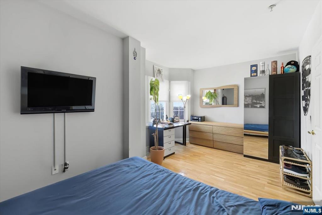 214 The Promenade, Unit 214 Edgewater, NJ 07020 - Photo 31 of 36 a view of a livingroom with furniture and wooden floor