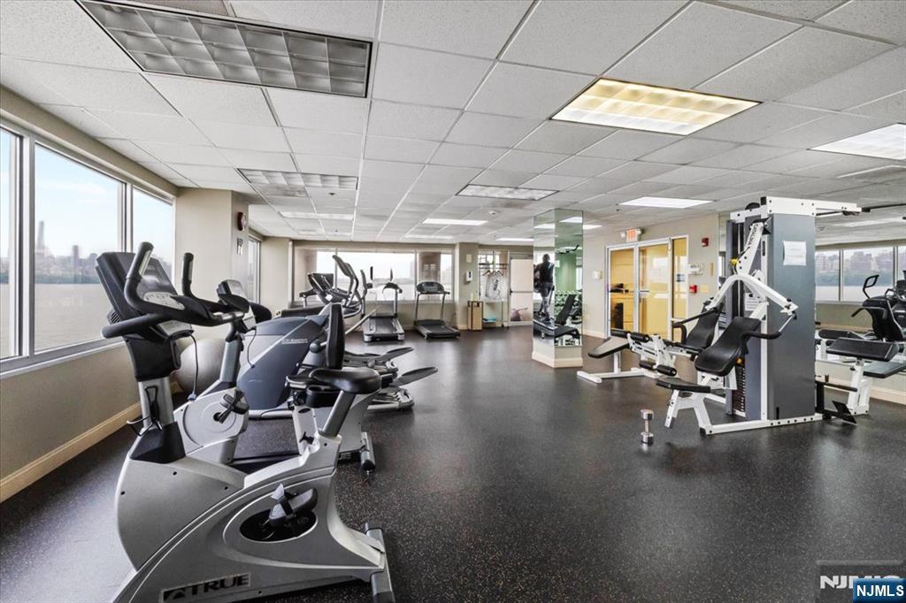 214 The Promenade, Unit 214 Edgewater, NJ 07020 - Photo 33 of 36 a gym room with lots of gym equipment