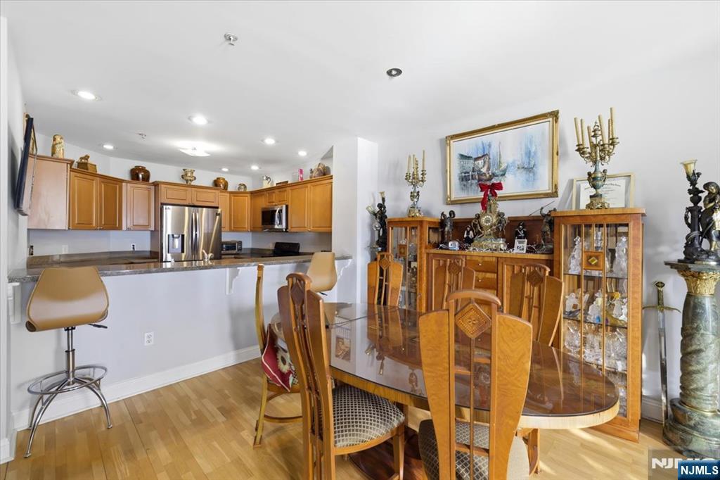 214 The Promenade, Unit 214 Edgewater, NJ 07020 - Photo 7 of 36 a view of a dining room with furniture