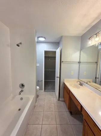 en empty room with windows and ceiling fan view