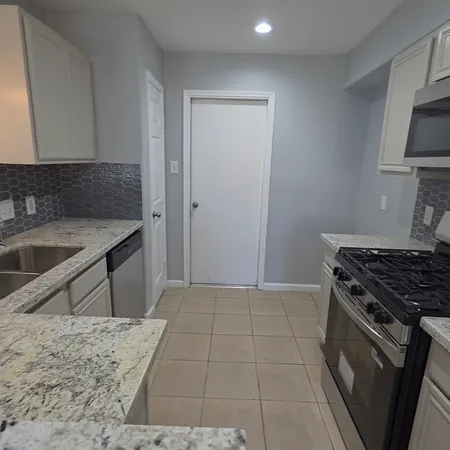 a kitchen with a stove and a sink