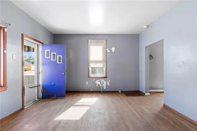 wooden floor in an empty room with a window