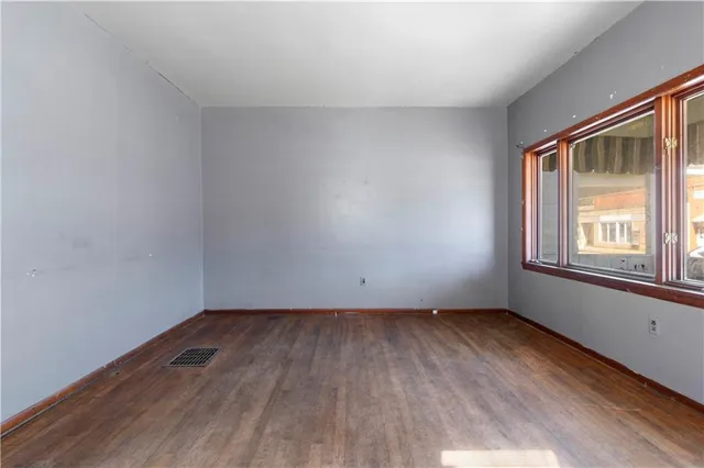 an empty room with window and entrance