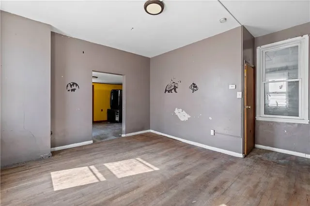 an empty room with windows and closet