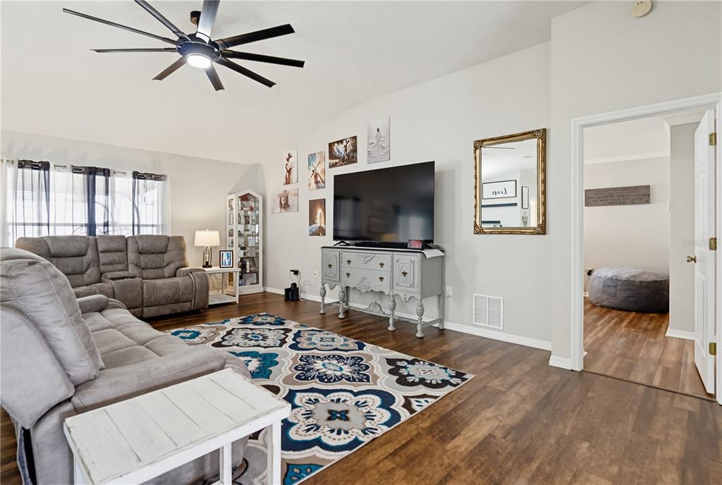 3497 Chadwick Avenue Spring Hill, FL 34609 - Photo 14 of 47 a living room with furniture and a flat screen tv