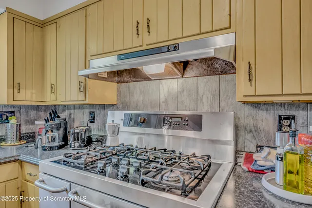 a bathroom with a granite countertop sink a mirror and a shower