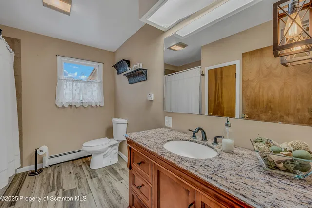 a view of a livingroom with wooden floor and a window