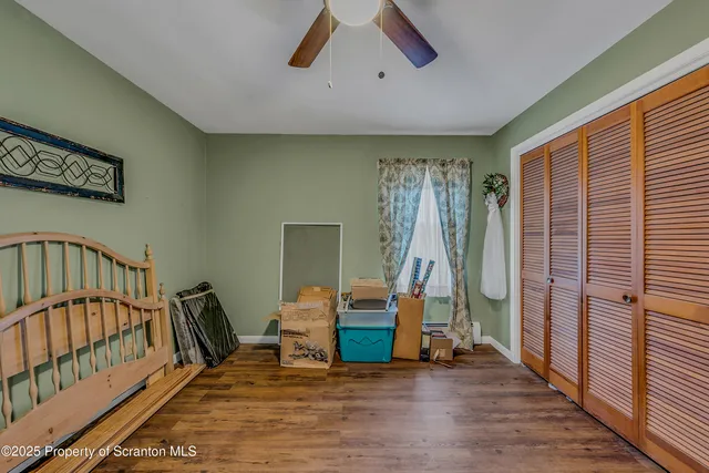 a bedroom with double bed and a dresser