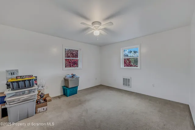 a bathroom with a toilet a sink and a mirror