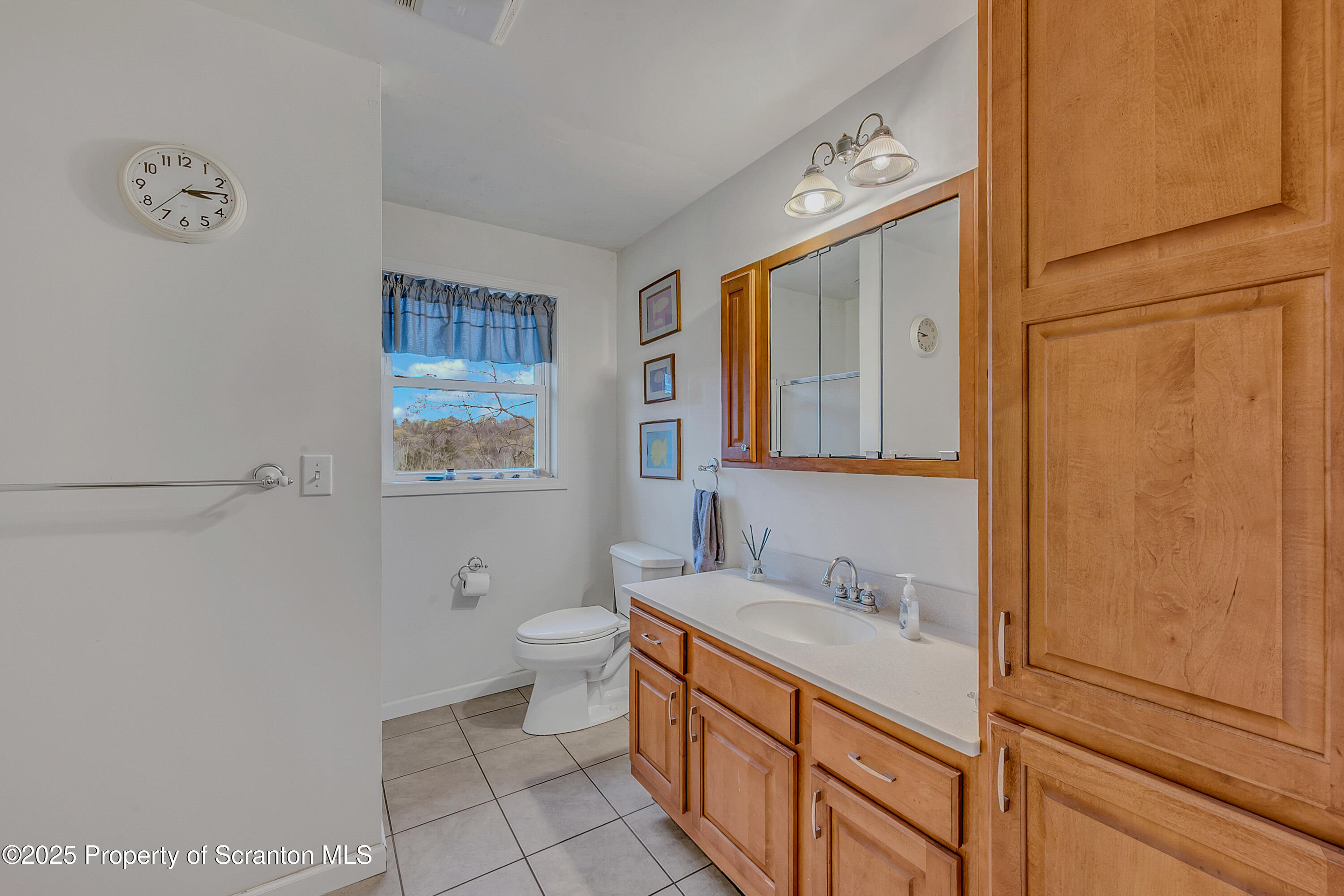 1001 Griggs Street Clarks Summit, PA 18411 - Photo 37 of 55 a spacious bathroom with a granite countertop sink toilet and a mirror