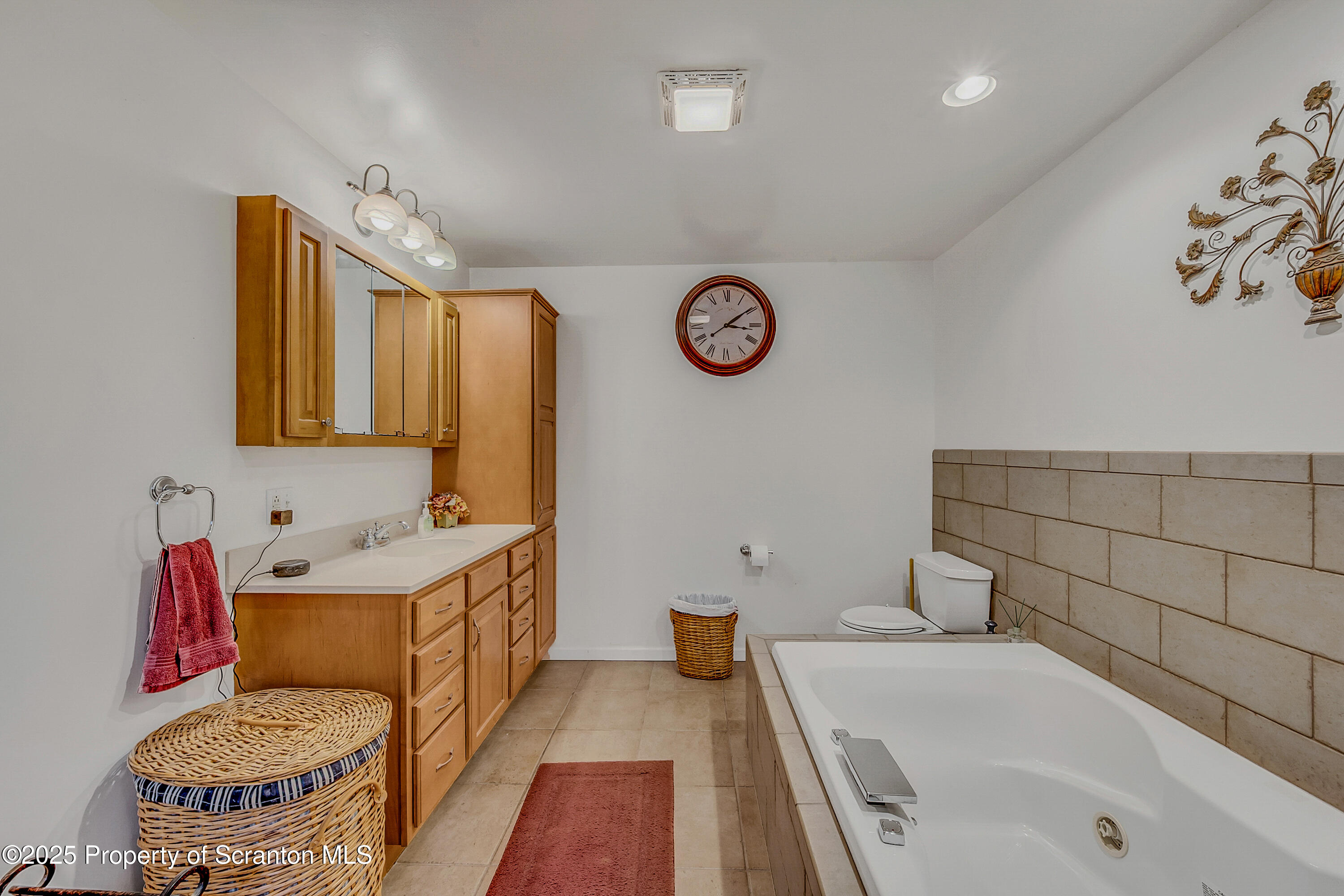 1001 Griggs Street Clarks Summit, PA 18411 - Photo 39 of 55 a bathroom with a tub sink and mirror
