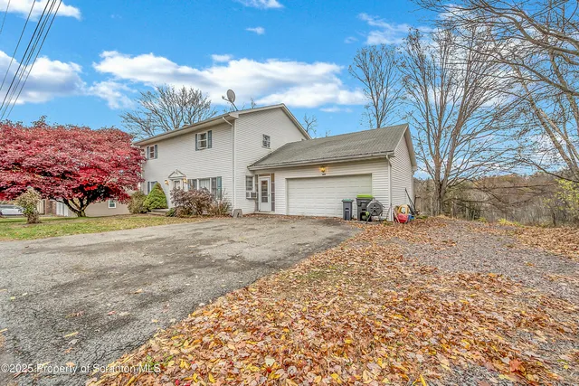 a view of a house with a yard and garage