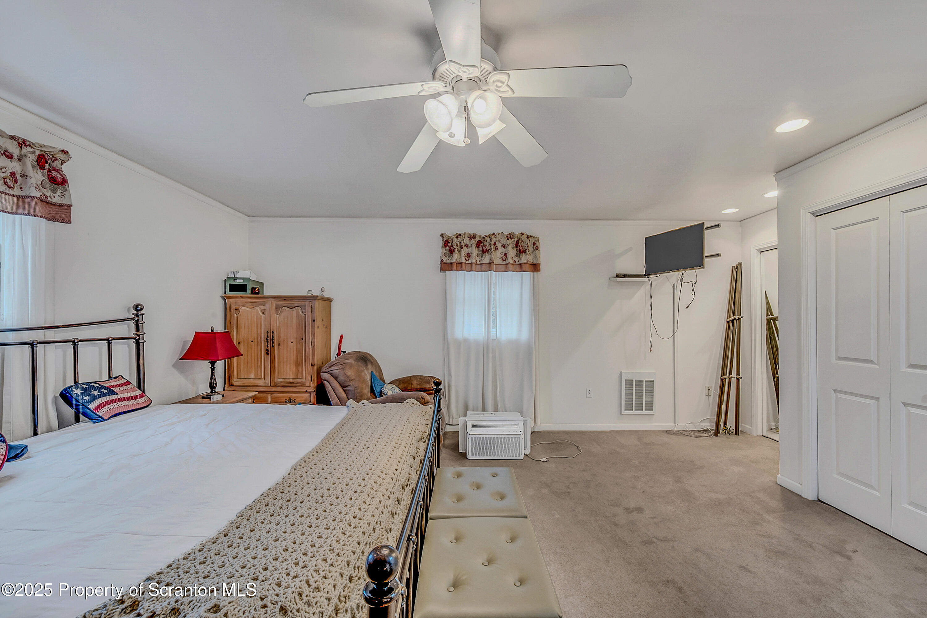 1001 Griggs Street Clarks Summit, PA 18411 - Photo 44 of 55 a view of a bedroom with a bed and a chandelier