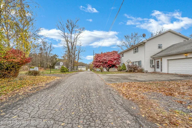 a view of a house with a yard and garage