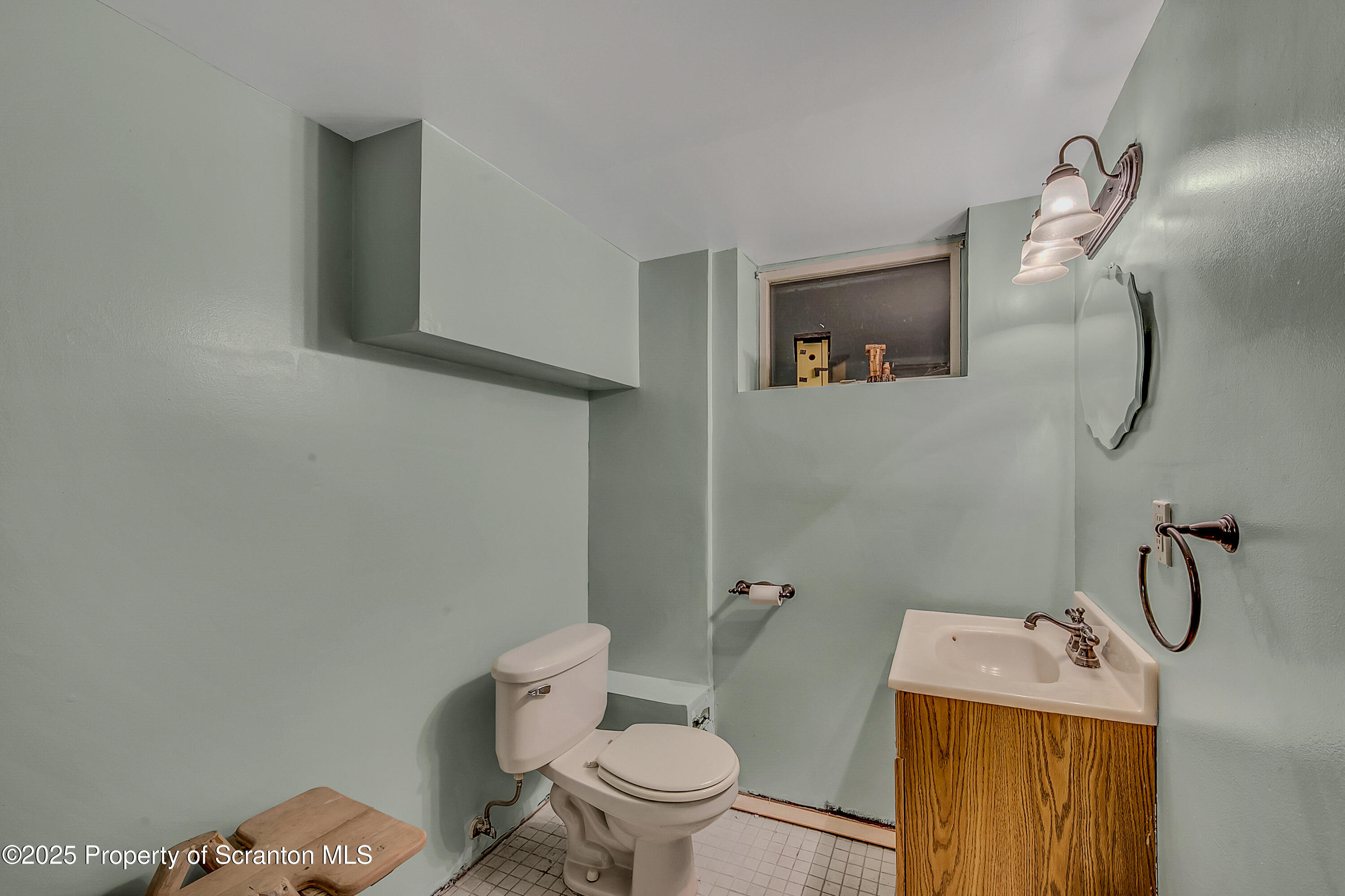 1001 Griggs Street Clarks Summit, PA 18411 - Photo 52 of 55 a bathroom with a granite countertop toilet and a sink