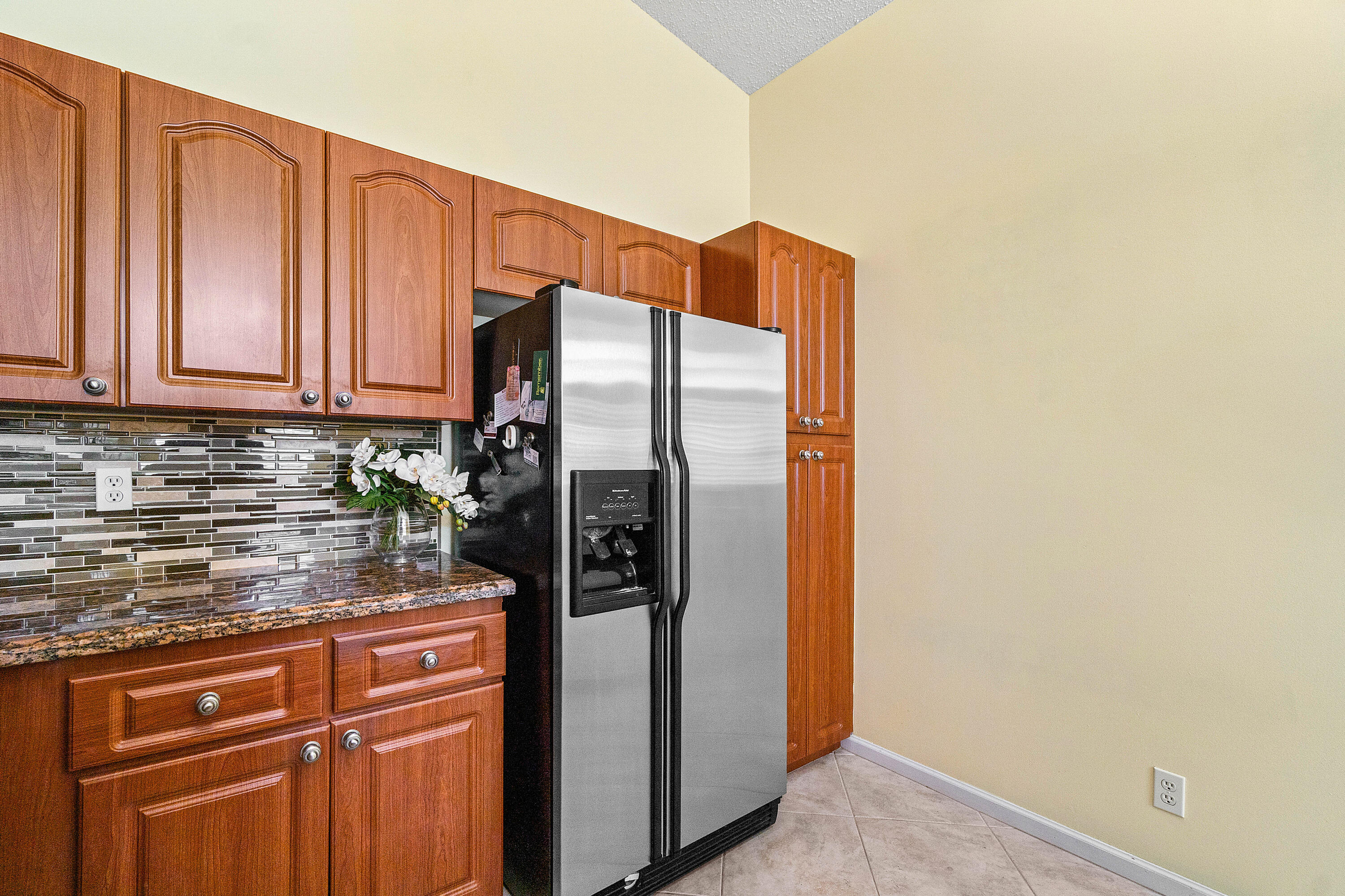 8918 Southeast Riverfront Terrace Jupiter, FL 33469 - Photo 14 of 43 a kitchen with stainless steel appliances granite countertop a refrigerator and a stove
