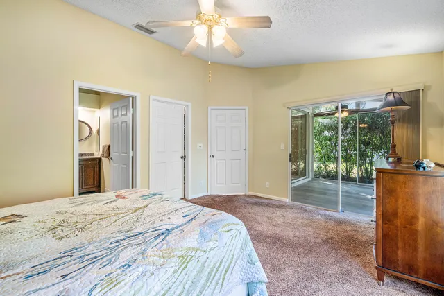 a bedroom with a bed and a large mirror