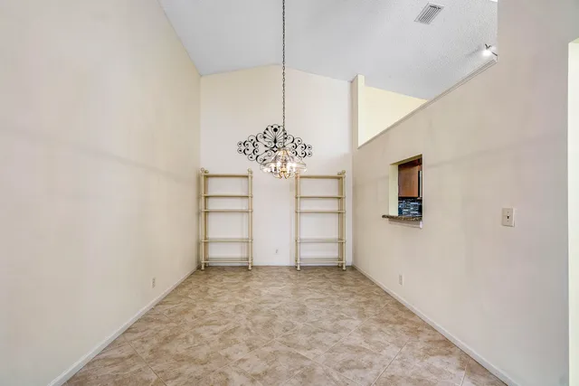 a view of a chandelier fan and refrigerator