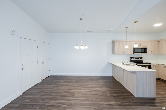 709 West 4500th South, Unit N302 Mapleton, UT 84664 - Photo 14 of 15 Kitchen with light wood finish cabinets, a peninsula, range with electric stovetop, hanging lights, and stainless steel microwave