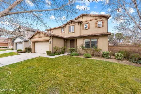 a view of a house with yard and tree s