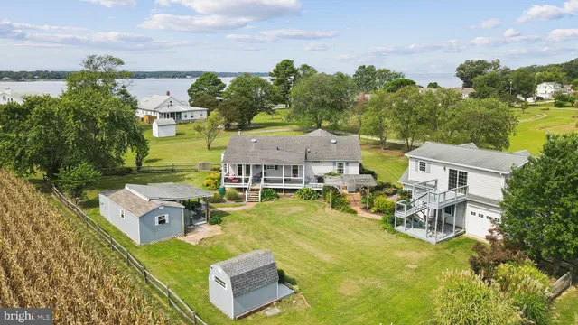 an aerial view of a house with swimming pool and green space